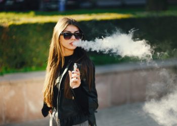 stylish girl smoking an e-cigarette