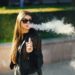 stylish girl smoking an e-cigarette